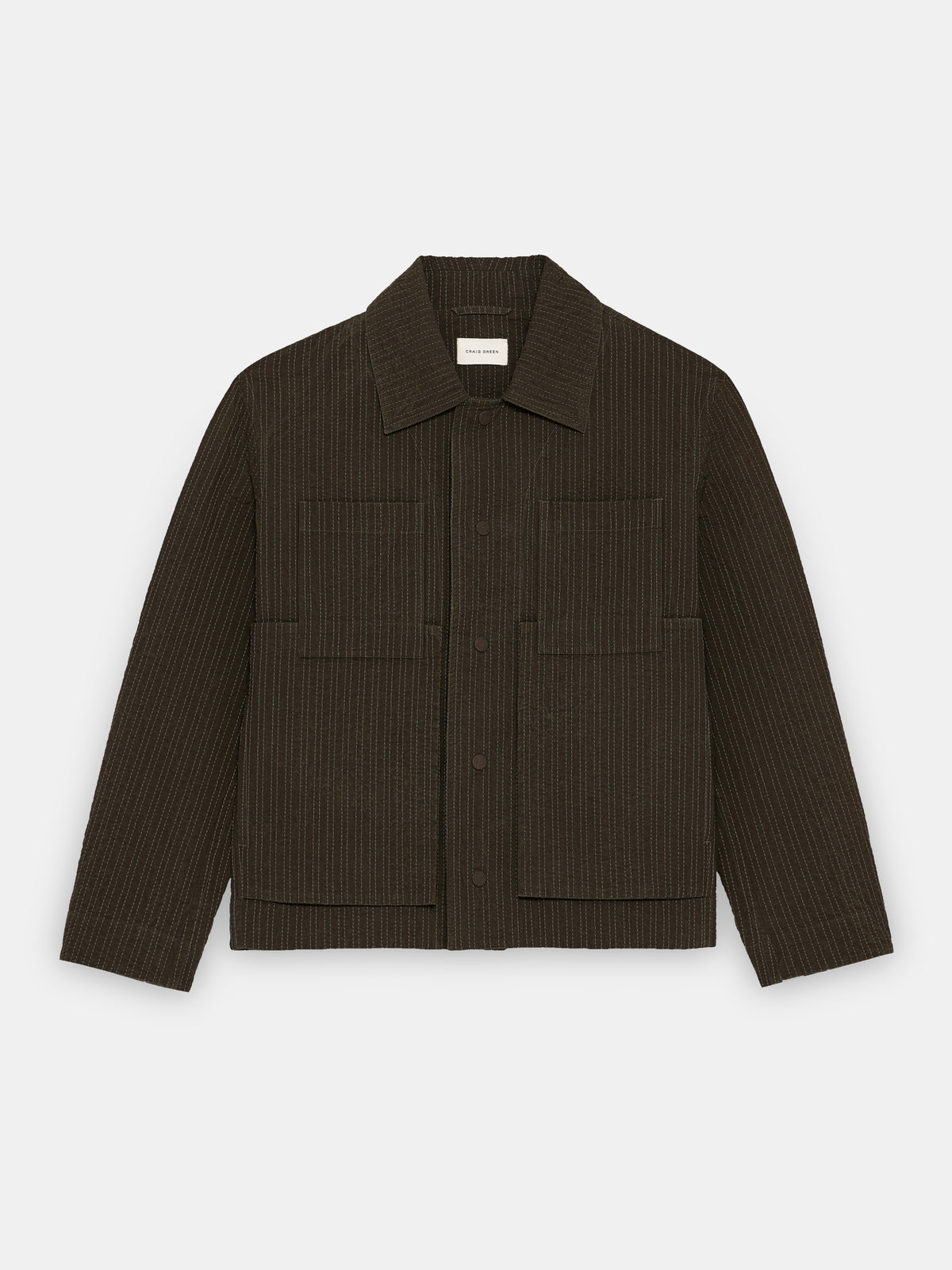 Green worker jacket by Craig Green featuring embroidered linestitch details and a flat front view.