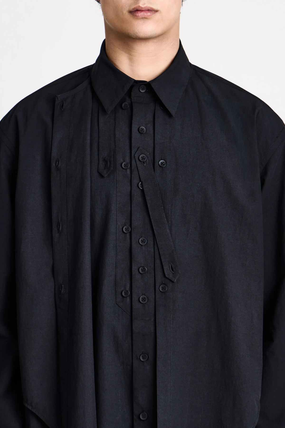 Model wearing the Craig Green black layered shirt highlighting the collar and button closure